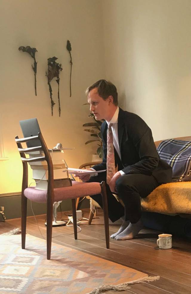 Orlando Reade sitting opposite a laptop computer